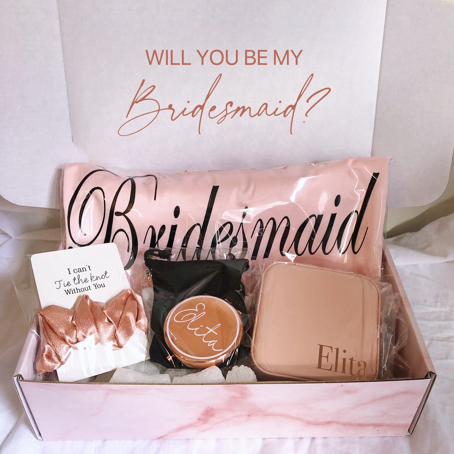 Our gift box includes personalized items like wedding robes, a compact mirror, travel jewelry box, and message scrunchies, offering a thoughtful and stylish gift for any special occasion.