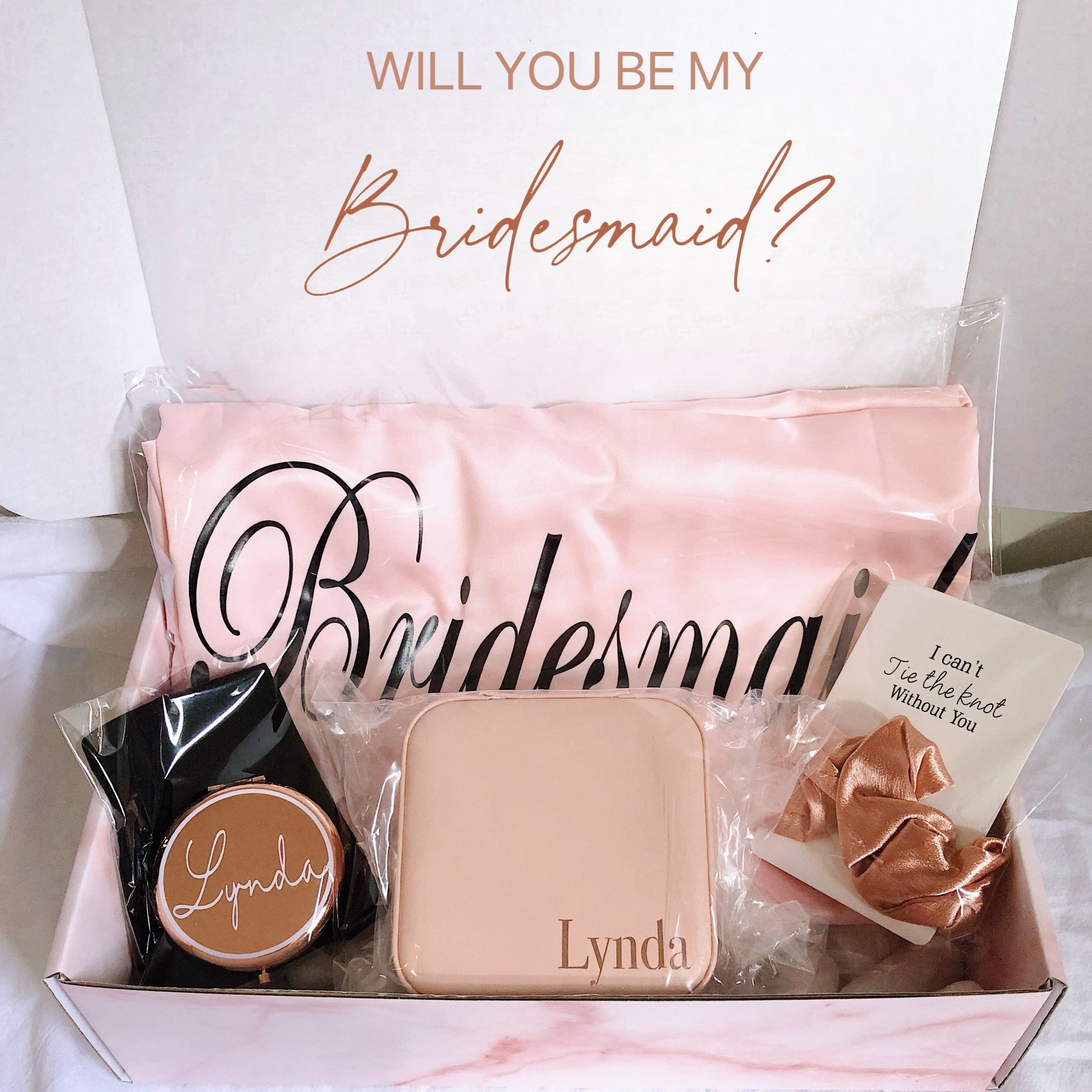 Our gift box includes personalized items like wedding robes, a compact mirror, travel jewelry box, and message scrunchies, offering a thoughtful and stylish gift for any special occasion.