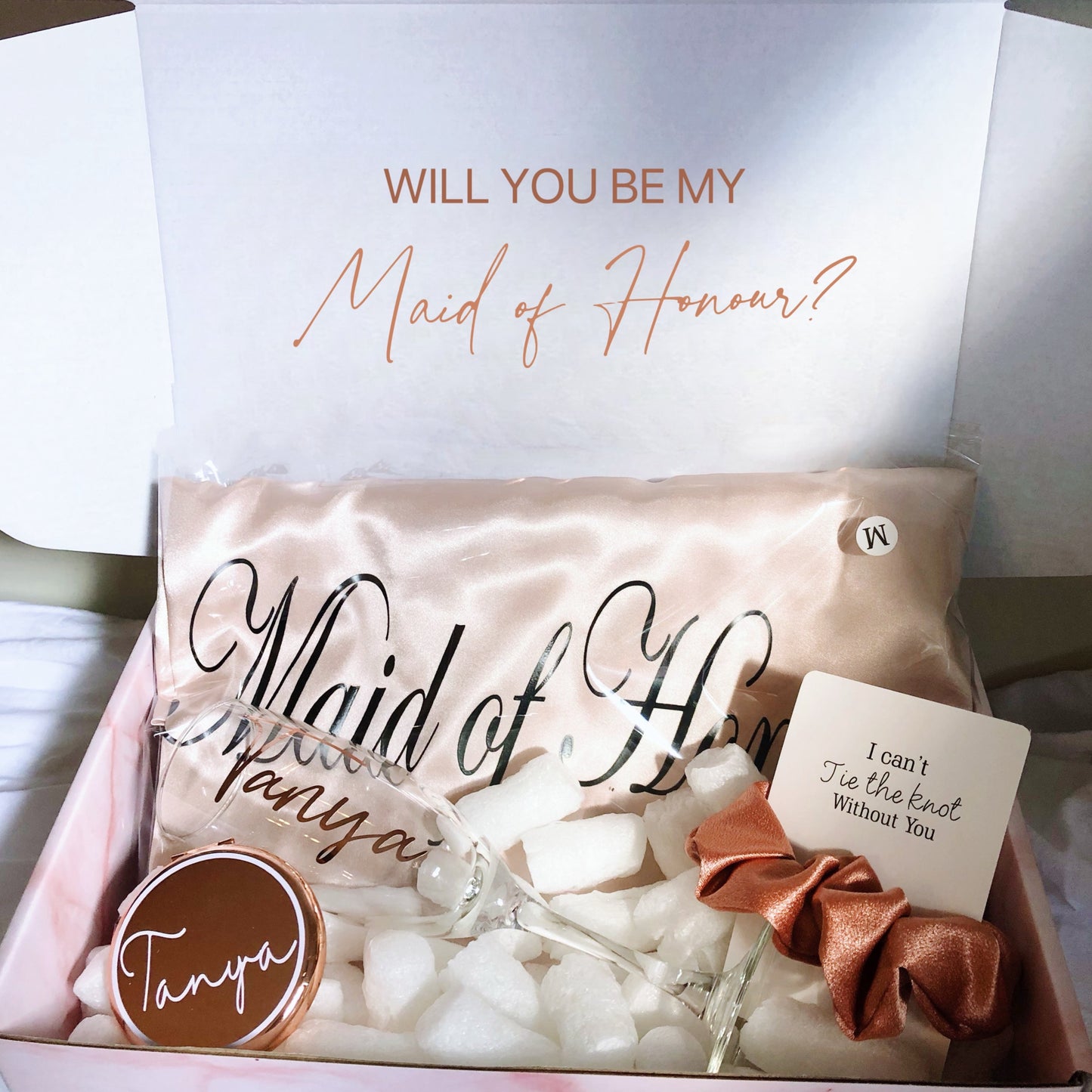 Our gift box includes personalized items like wedding robes, a compact mirror, travel jewelry box, and message scrunchies, offering a thoughtful and stylish gift for any special occasion.