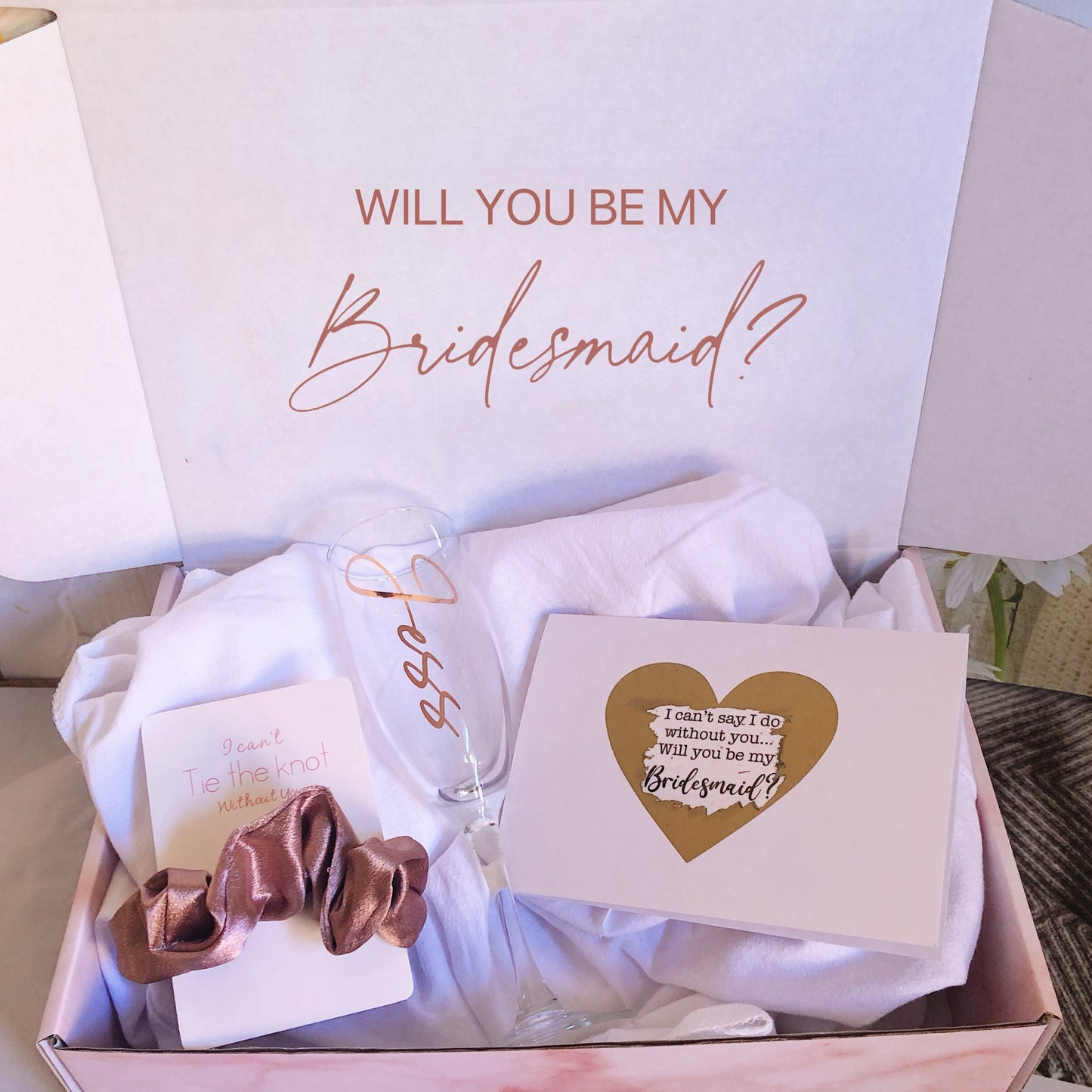 Our personalized gift box, perfect for any special occasion, includes a customized box, card, champagne flute or stemless glass, and message scrunchies, available in elegant Marble Pink or White Ribbon.