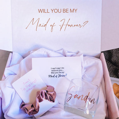 Our personalized gift box, perfect for any special occasion, includes a customized box, card, champagne flute or stemless glass, and message scrunchies, available in elegant Marble Pink or White Ribbon.