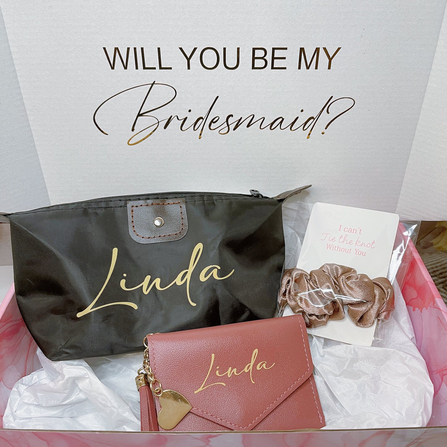 Our gift box for bridesmaid proposals includes a personalized box, wallet in 3 colors, makeup bag, and message scrunchies, offering a thoughtful and stylish way to ask your bridesmaids to be part of your special day.