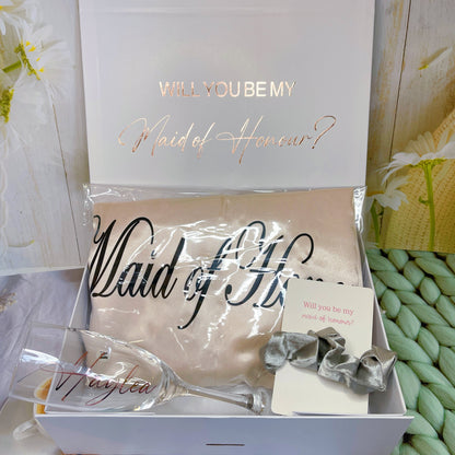 Our personalized gift box, perfect for any special occasion, includes a customized box, card, champagne flute or stemless glass, and message scrunchies, available in elegant Marble Pink or White Ribbon.