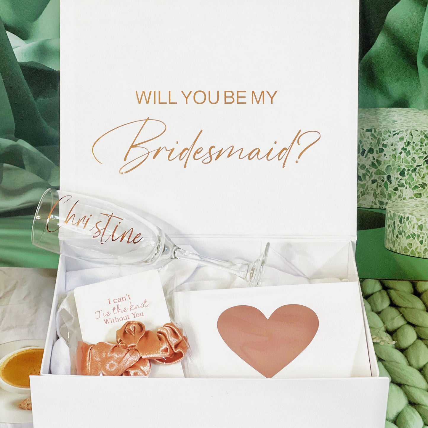 Our personalized gift box, perfect for any special occasion, includes a customized box, card, champagne flute or stemless glass, and message scrunchies, available in elegant Marble Pink or White Ribbon.