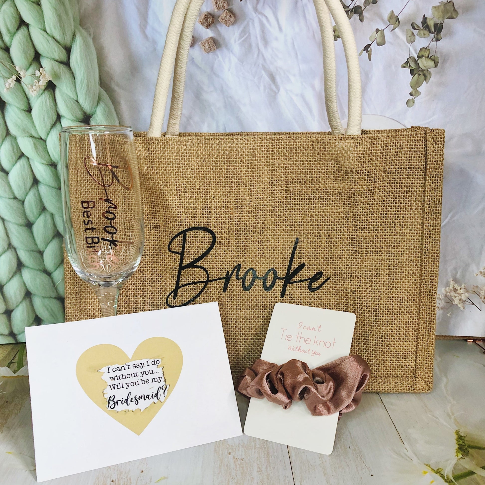 Our bundle includes a personalized jute bag, bridesmaid or Maid of Honour card, champagne flute or stemless glass, and message scrunchies, perfect for stylish and heartfelt bridal party gifts.