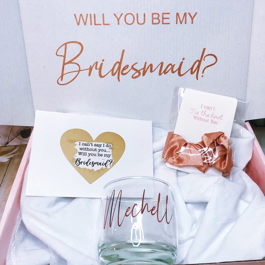 Our personalized gift box, perfect for any special occasion, includes a customized box, card, champagne flute or stemless glass, and message scrunchies, available in elegant Marble Pink or White Ribbon.