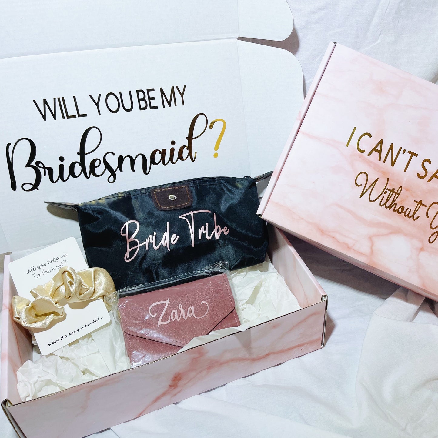 Our gift box for bridesmaid proposals includes a personalized box, wallet in 3 colors, makeup bag, and message scrunchies, offering a thoughtful and stylish way to ask your bridesmaids to be part of your special day.